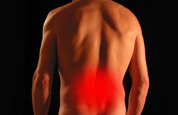 Man's back with a red circle to show back pain
